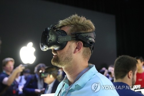 지난해 6월 애플 개발자회의에서 한 방문자가 애플의 VR 애플리케이션을 테스트하고 있다