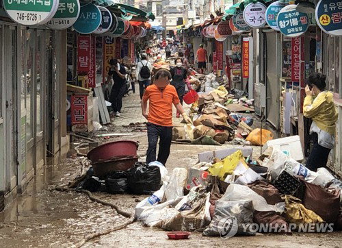 비 피해 복구 나선 부산 상인들 지난 24일 오후 부산 해운대구 해운대시장 일대에서 상인들이 집중호우 피해 복구를 하는 모습.2020.7.26